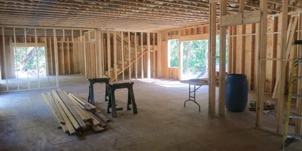 17 Oaks Plantation — interior wall framing showing stud walls, staircase, and open floor plan under construction